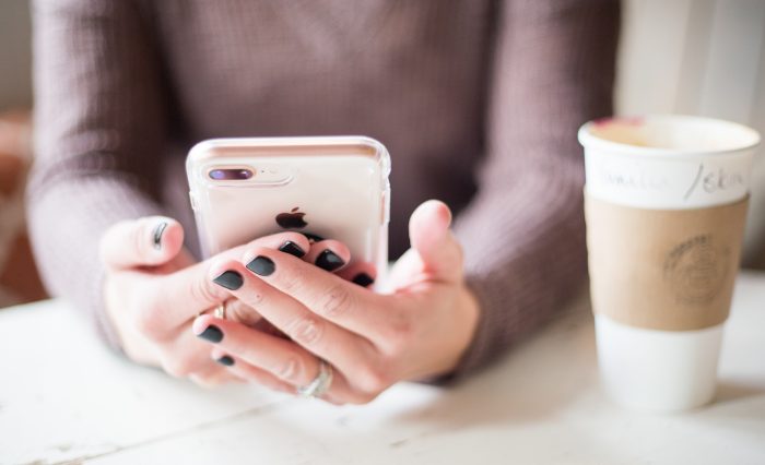 negative-space-hands-phone-nails-coffee